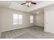 Spacious main bedroom featuring tray ceilings, neutral carpet and ample natural light at 6111 Panache Dr, Matthews, NC 28104