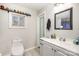 Updated bathroom with modern vanity, toilet, mirror, and new tile flooring offers a clean, refreshed look at 705 Sumter St, Lancaster, SC 29720
