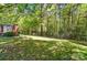 This large backyard is fenced and includes a partial view of the brick home at 73 Wyth Sw Ct, Concord, NC 28025