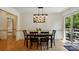 Inviting dining room featuring a modern light fixture and a door that leads to the outdoor patio at 73 Wyth Sw Ct, Concord, NC 28025