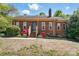 Charming brick home featuring a well-maintained lawn, red flower bushes, and a classic chimney at 73 Wyth Sw Ct, Concord, NC 28025