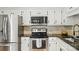 Renovated kitchen with stainless steel appliances, white cabinets, and dark countertops at 73 Wyth Sw Ct, Concord, NC 28025