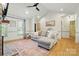 Bright living room featuring vaulted ceilings, gray sofa, and wood floors with a decorative rug at 73 Wyth Sw Ct, Concord, NC 28025