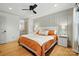 Bright main bedroom featuring hardwood floors, a decorative accent wall, and modern ceiling fan at 73 Wyth Sw Ct, Concord, NC 28025