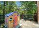 This lovely backyard patio includes a playhouse, two chairs, and wrought iron railings at 73 Wyth Sw Ct, Concord, NC 28025