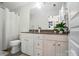 Bright bathroom featuring a vanity, toilet, mirror, and house plants at 8504 Sunset Hill Rd, Waxhaw, NC 28173