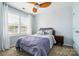 Cozy bedroom featuring a ceiling fan, large window and neutral color palette at 8504 Sunset Hill Rd, Waxhaw, NC 28173
