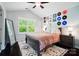 Bedroom featuring a large window, ceiling fan, hard wood floors and a collection of records at 8504 Sunset Hill Rd, Waxhaw, NC 28173