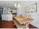 Open concept dining room with wood table and bench seating adjacent to the kitchen at 8504 Sunset Hill Rd, Waxhaw, NC 28173