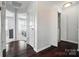Hallway with dark wood floors leads to the bedrooms and the laundry room at 8504 Sunset Hill Rd, Waxhaw, NC 28173