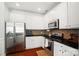 Modern kitchen featuring white cabinets, stainless steel appliances, granite countertops and tile backsplash at 8504 Sunset Hill Rd, Waxhaw, NC 28173