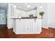 Open kitchen with a central island, modern appliances, and clean white cabinetry at 8504 Sunset Hill Rd, Waxhaw, NC 28173