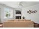 Bright living room with fireplace, built-in shelving, ceiling fan, and neutral color palette at 8504 Sunset Hill Rd, Waxhaw, NC 28173