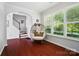 Bright living room with a wicker chair, stairs, and abundant natural light at 8504 Sunset Hill Rd, Waxhaw, NC 28173