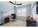 Bright home office with a ceiling fan, large window, and work station at 8504 Sunset Hill Rd, Waxhaw, NC 28173