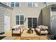 Cozy patio featuring outdoor seating, a golden table, and a sliding glass door at 8504 Sunset Hill Rd, Waxhaw, NC 28173