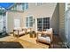 Inviting patio area with modern furniture and a round accent table, perfect for relaxation at 8504 Sunset Hill Rd, Waxhaw, NC 28173