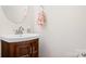 Powder room featuring wood vanity with a round mirror at 8524 Sunset Hill Rd, Waxhaw, NC 28173