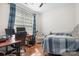 Well-lit bedroom featuring a large window, desk, and comfortable bedding at 8524 Sunset Hill Rd, Waxhaw, NC 28173