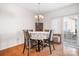 Bright dining area featuring a table with floral tablecloth, and a sliding glass door to the back patio at 8524 Sunset Hill Rd, Waxhaw, NC 28173