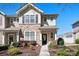 Attractive two-story home with stone details and welcoming front entrance with blue sky background at 8524 Sunset Hill Rd, Waxhaw, NC 28173