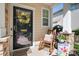Close-up of a welcoming front door featuring a wreath, rocking chair and 'welcome' sign at 8524 Sunset Hill Rd, Waxhaw, NC 28173
