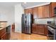 Kitchen view with stainless steel refrigerator and wooden cabinets at 8524 Sunset Hill Rd, Waxhaw, NC 28173