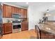 Well-lit kitchen features stainless steel appliances and granite countertops at 8524 Sunset Hill Rd, Waxhaw, NC 28173