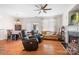 Cozy living area with hardwood floors, ceiling fan, fireplace and casual decor at 8524 Sunset Hill Rd, Waxhaw, NC 28173