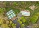 Aerial view showcases community pool, tennis courts, parking and playground among the trees at 8604 Cedardale Ridge Ct, Charlotte, NC 28269