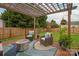 Cozy backyard patio featuring a pergola, comfortable seating, and lush greenery, perfect for relaxing outdoors at 8604 Cedardale Ridge Ct, Charlotte, NC 28269