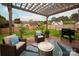 A relaxing backyard, featuring a fire pit, comfortable seating area, and a built-in grill at 8604 Cedardale Ridge Ct, Charlotte, NC 28269
