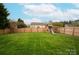 Expansive backyard featuring a swing set, ideal for children to play and enjoy the outdoors at 8604 Cedardale Ridge Ct, Charlotte, NC 28269