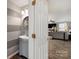 Charming half bathroom with stylish vanity, mirror, and gray and white horizontally striped walls at 8604 Cedardale Ridge Ct, Charlotte, NC 28269
