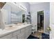 Bright bathroom featuring double sinks, wood floors, and a separate wardrobe area at 8604 Cedardale Ridge Ct, Charlotte, NC 28269