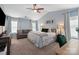 Spacious main bedroom offering a vaulted ceiling, ceiling fan, sitting area, and natural light at 8604 Cedardale Ridge Ct, Charlotte, NC 28269