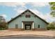 Community clubhouse featuring a brick base, green siding, and covered entrance at 8604 Cedardale Ridge Ct, Charlotte, NC 28269
