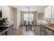 Kitchen dining area featuring wood floors, a glass table set, and natural lighting at 8604 Cedardale Ridge Ct, Charlotte, NC 28269
