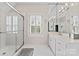 Bathroom with glass shower, window, and vanity with mirror and Hollywood lighting at 8934 Winged Bourne Dr, Charlotte, NC 28210