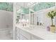 Bathroom with vintage wallpaper, white cabinets, and a large mirror over the vanity at 8934 Winged Bourne Dr, Charlotte, NC 28210