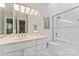 Clean bathroom with a vanity, mirror with lighting, a toilet, and a glass-enclosed tub/shower at 8934 Winged Bourne Dr, Charlotte, NC 28210