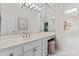 Bright bathroom with double vanity, framed mirror, built-in makeup table, and walk-in shower at 8934 Winged Bourne Dr, Charlotte, NC 28210