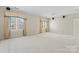 Large bonus room with neutral carpet, crown molding, two windows, and a ceiling fan at 8934 Winged Bourne Dr, Charlotte, NC 28210