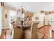 Formal dining room with a chandelier, access to the kitchen and great natural light at 8934 Winged Bourne Dr, Charlotte, NC 28210