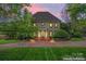 Stately home with a brick driveway, manicured landscaping, and a classic facade at 8934 Winged Bourne Dr, Charlotte, NC 28210