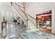 Grand foyer with marble floors, a sweeping staircase, and views into a dining room and living room with piano at 8934 Winged Bourne Dr, Charlotte, NC 28210