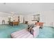 Expansive game room featuring a pool table, lounge area, and a small bar setup at 8934 Winged Bourne Dr, Charlotte, NC 28210