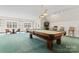 Large game room with a pool table, seating area, and ample natural light from surrounding windows at 8934 Winged Bourne Dr, Charlotte, NC 28210
