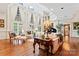Bright and airy living room featuring soaring windows, hardwood floors, and a grand piano at 8934 Winged Bourne Dr, Charlotte, NC 28210