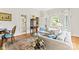 Bright living room with hardwood floors, large windows, and elegant decor at 8934 Winged Bourne Dr, Charlotte, NC 28210